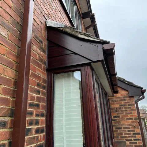 Side of Wallisdown property after Rosewood UPVC Cladding and Rosewood UPVC fascias and soffits and brown square guttering replacement 