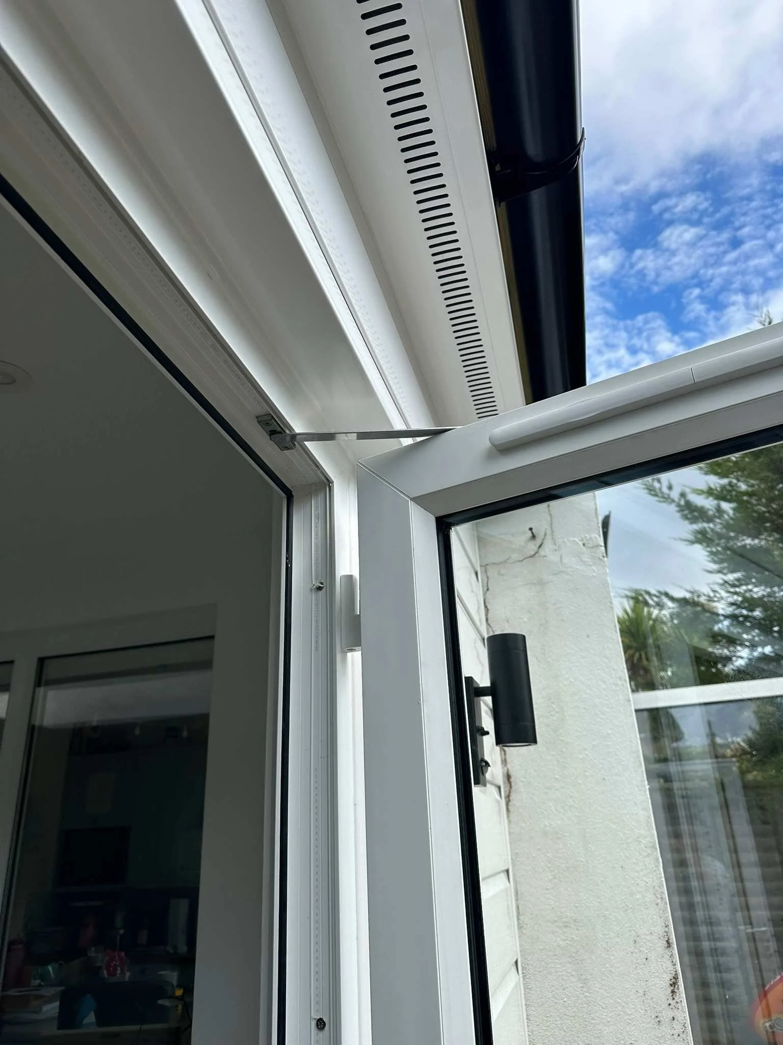 rehau french doors fitted with restrictor hinges with vented soffit above.jpg