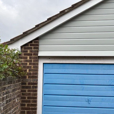 front view of the garage fitted with new white upvc bargeboards and agate grey cladding
