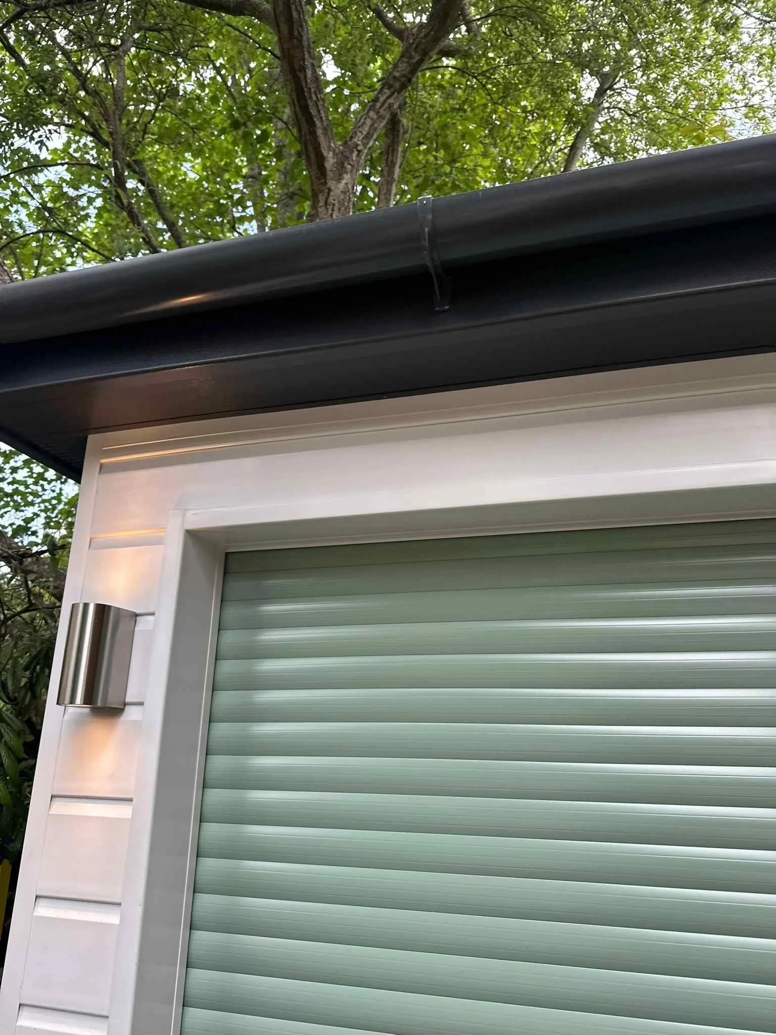 white UPVC shiplap with chartwell green door and antracite fascias and soffits.jpg