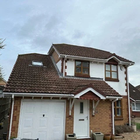 Image showing front of detached property in Broadstone, Poole with new white UPVC Fascias, white UPVC tongue and grove Soffits and white square UPVC guttering