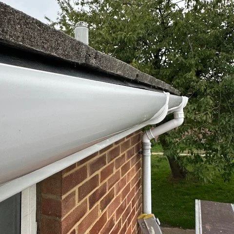 close up of newly fitted white deep flow guttering fitted to a house