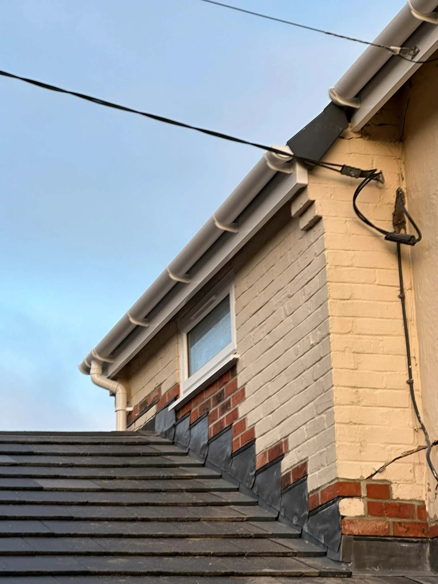 white UPVC roofline and cables refixed.jpg