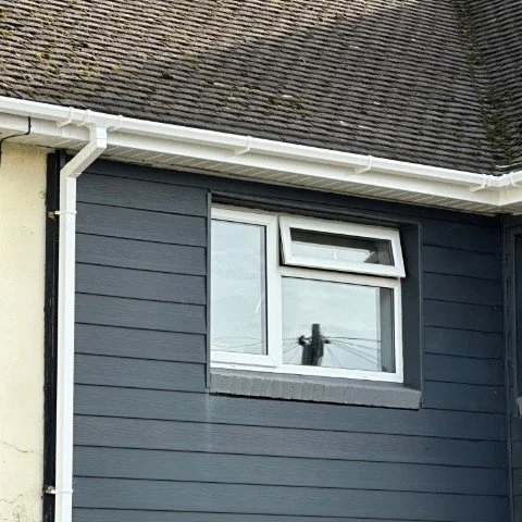 front view of a semi-detached property in Poole fitted with new white UPVC fascias and white square UPVC  guttering and white square UPVC downpipes 