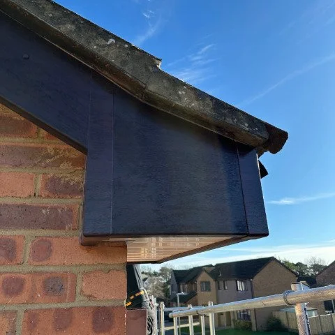 Image shows a close up of new Rosewood UPVC bargeboards and box ends in Poole Dorset