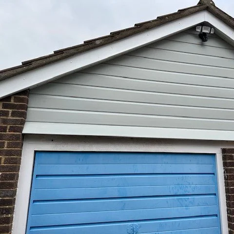 view of the front of the garage fitted with new agate grey shiplap cladding