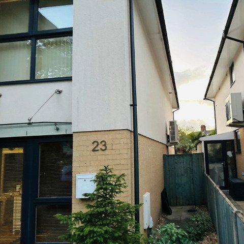 Image shows new black UPVC guttering and black UPVC downpipe replacement on the front and side of a detached property in Poole, Dorset after guttering repair