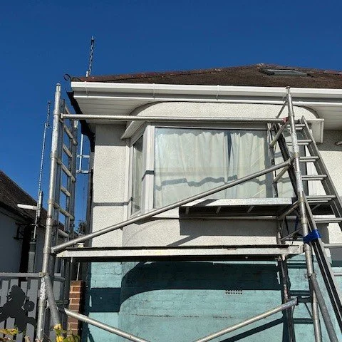 front corner view of the bungalow showing newly fitted white UPVC fascias and guttering