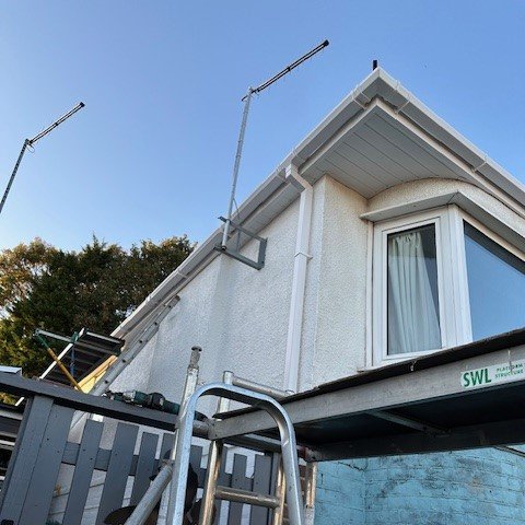 corner view of the bungalow showing new white tongue and groove soffits and white square guttering