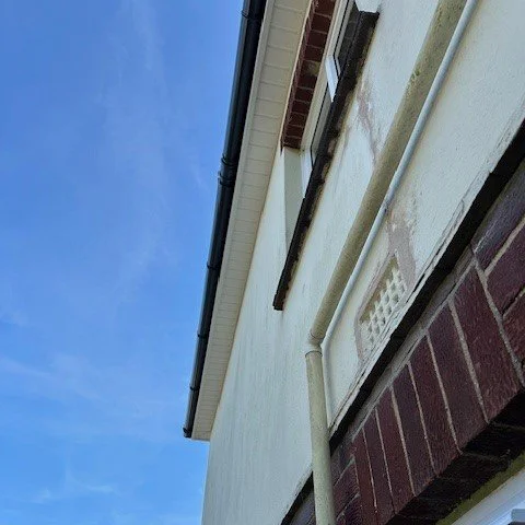 side of a detached property with newly fitted white fascias and soffits