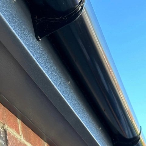 Image showing the close of of new anthracite grey UPVC fascias and soffits and black UPVC half round guttering in Poole, Dorset
