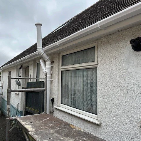 side view of the bungalow showing new white square guttering with new white soffits and fascias 