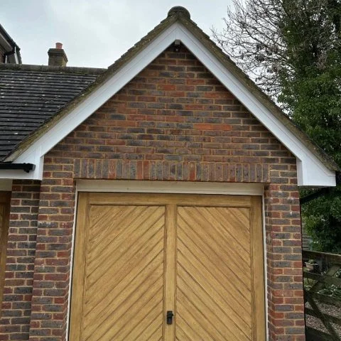 image shows garage on detached property in Wimborne Dorset with replacement white UPVC bargeboards 