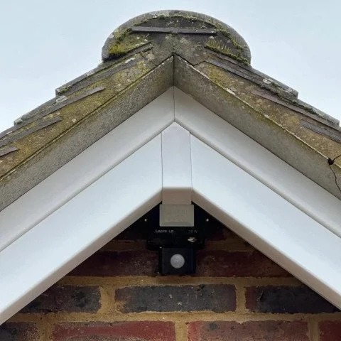 Image shows close up of replacement white UPVC bargeboards and architraves in Wimborne Dorset