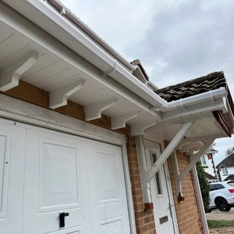 Image showing front of detached property in Broadstone, Poole with new white UPVC Fascias, white UPVC tongue and grove Soffits and white square UPVC guttering