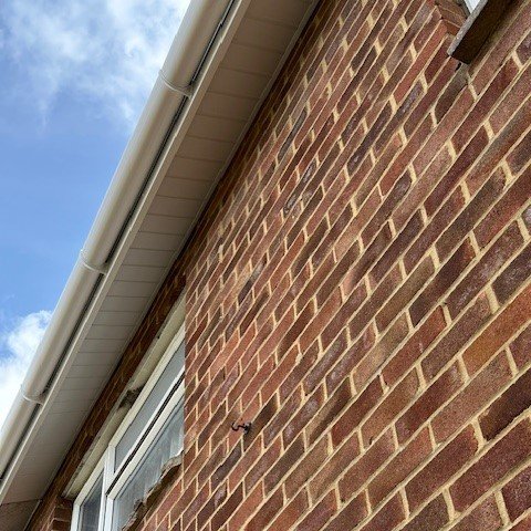 side view of a brick built property showing incline white tongue and groove soffits