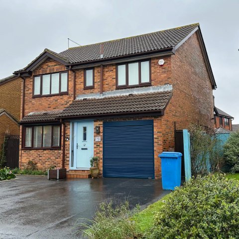 Image shows property in Wallisdown, Poole, with finished Rosewood UPVC fascias and white UPVC tongue and groove soffits and new brown square UPVC guttering