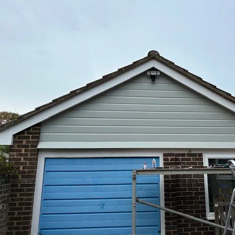 front view of the garage with newly fitted agate grey cladding and white bargeboards and soffits