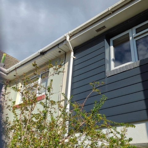 Image showing the front view of a semi-detached property in Poole before it is fitted with new white UPVC fascias and white UPVC square guttering