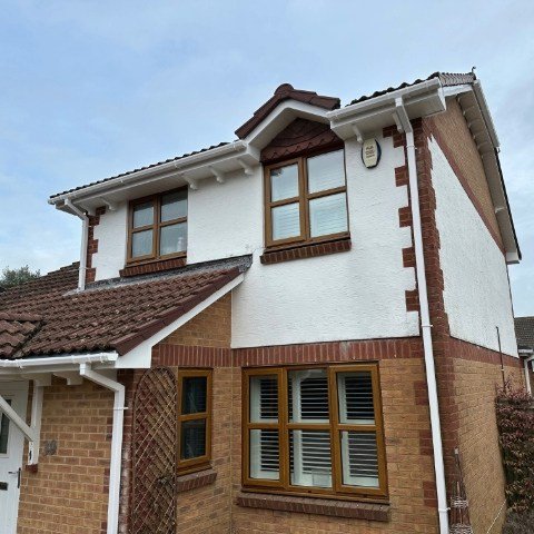 Image showing front and side of detached property in Broadstone, Poole with new white UPVC Fascias, white UPVC tongue and grove Soffits and white square UPVC guttering