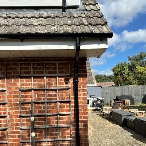 corner view of the bungalow showing new fascia and new black half round guttering and pipe