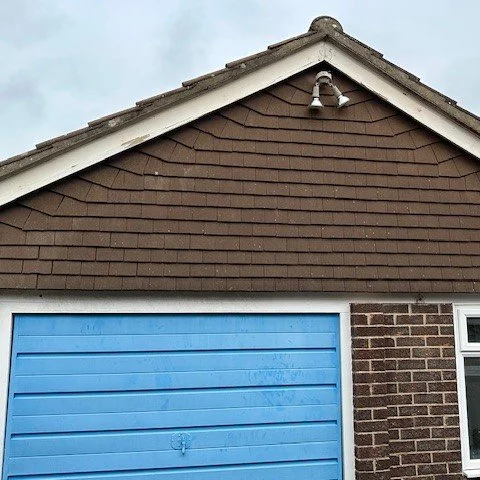 view of the front of the garage fitted with tiles before they are removed to fit cladding