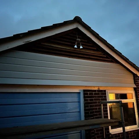 image showing cladding being fitted to the front of a garage 