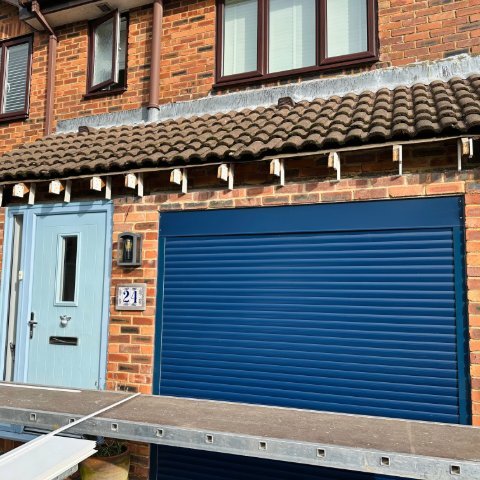 Image shows the front of a detached property in Wallisdown, Poole, before installing new Rosewood UPVC fascias, white UPVC tongue and groove soffits and brown square UPVC guttering