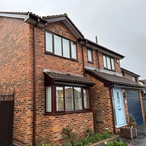 Front and side of Wallisdown property after Rosewood UPVC Cladding and Rosewood UPVC fascias and white UPVC tongue and groove soffits and brown square guttering replacement 