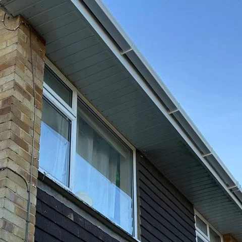Image shows close up of new white UPVC tongue and groove soffits and white square UPVC guttering in Southampton, Hampshire