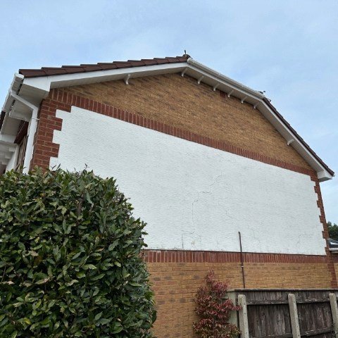 Image showing side of detached property in Broadstone, Poole with new white UPVC bargeboards, white UPVC tongue and grove Soffits and white square UPVC guttering