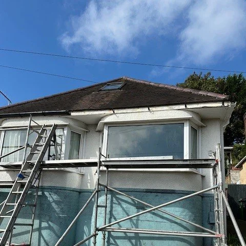 front of the bungalow with scaffold set up to fit new fascias and guttering