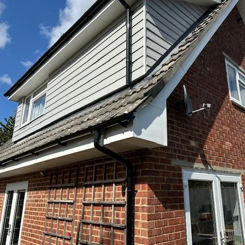 image showing the corner of the bungalow with newly fitted white bargeboards and black round guttering