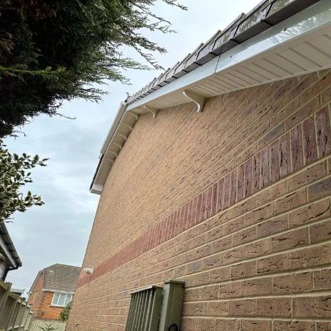Side image of house in Broadstone Poole with new UPVC Fascias and Soffits and white UPVC bargeboards