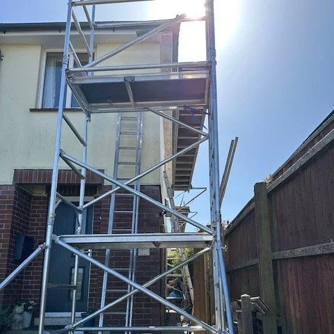 using our own scaffolding to access the narrow side of the property to fit UPVC Fascias and Soffits