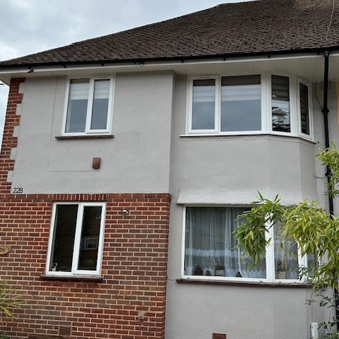 front of a 3 bed house just painted with sandtex paint with new white fascias and soffits