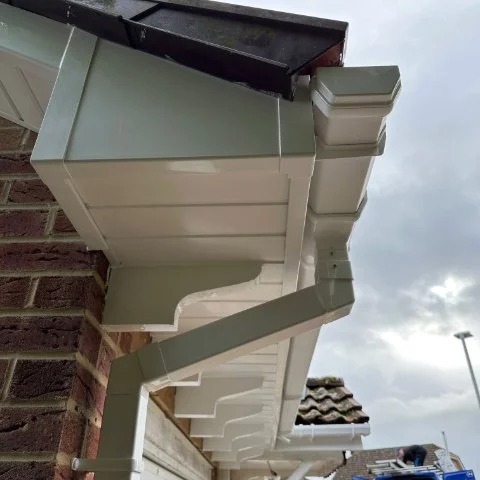 Close up of white UPVC bargeboards and box ends and square white down pipe in Poole