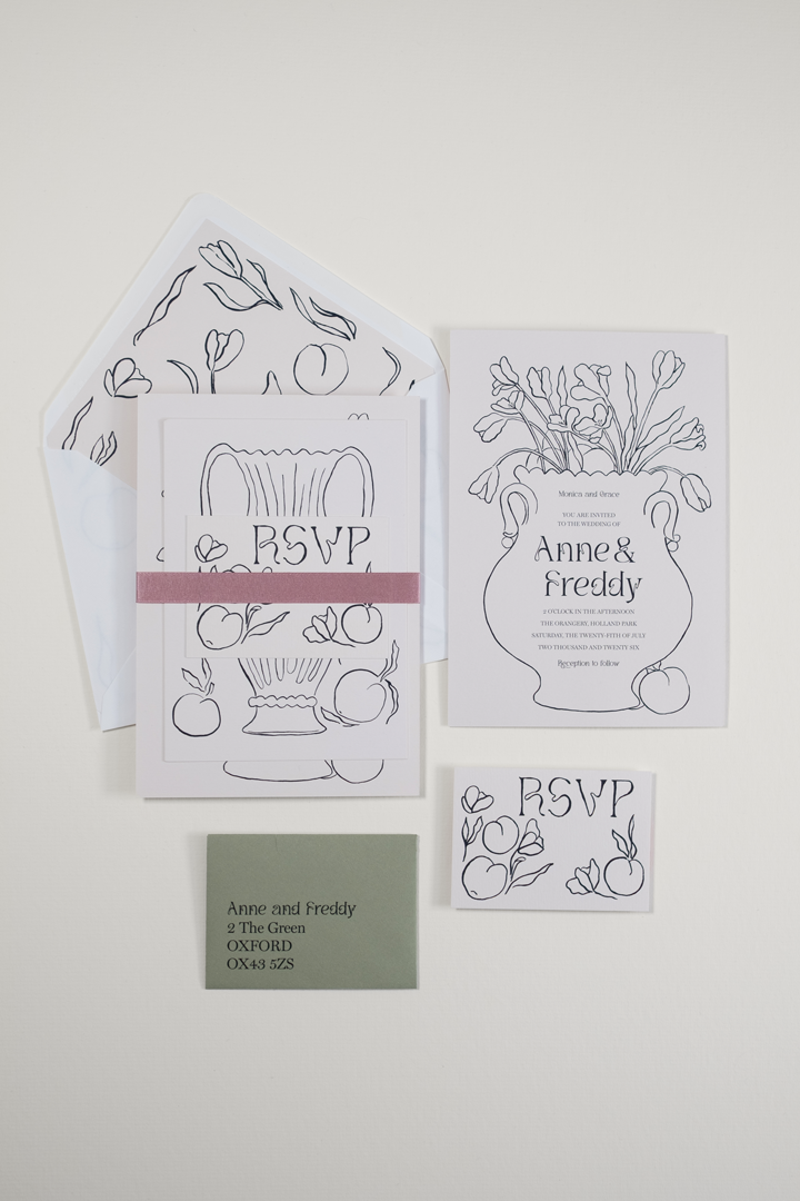 The Tulips wedding invitation suite bound by a rose double-faced satin ribbon band, displayed beside the flat-laid RSVP and invitation reverse details and envelope.