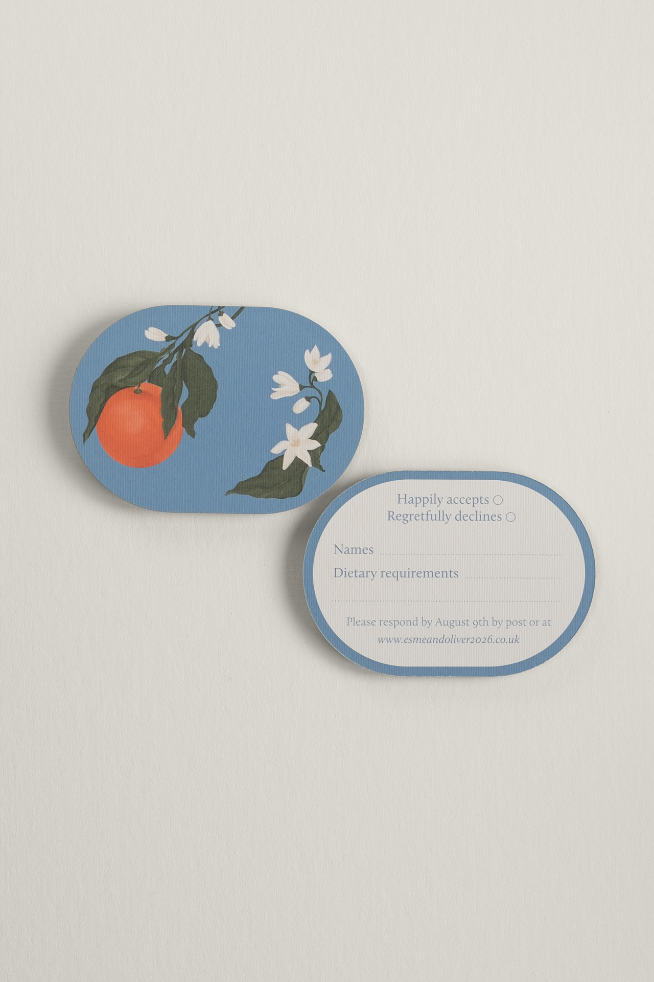 Front and reverse view of the double-arched Orangery wedding RSVP card, showing a vibrant citrus orange illustration on a sky-blue backdrop alongside a clean reply layout.