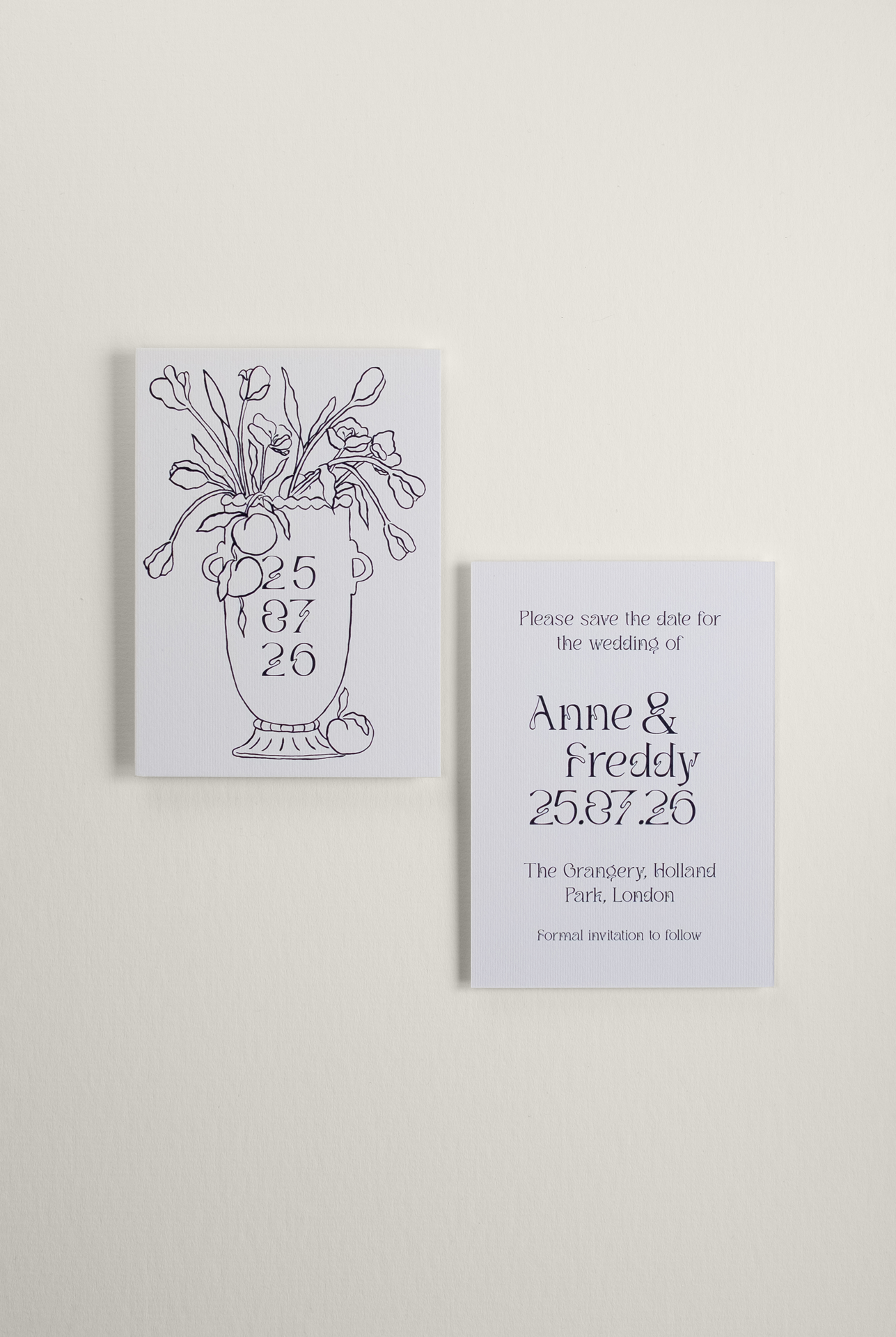 Flat lay view of the printed Tulips wedding Save the Date card, displaying a detailed monochromatic ink illustration of a vase brimming with tulips alongside the graphic reverse.