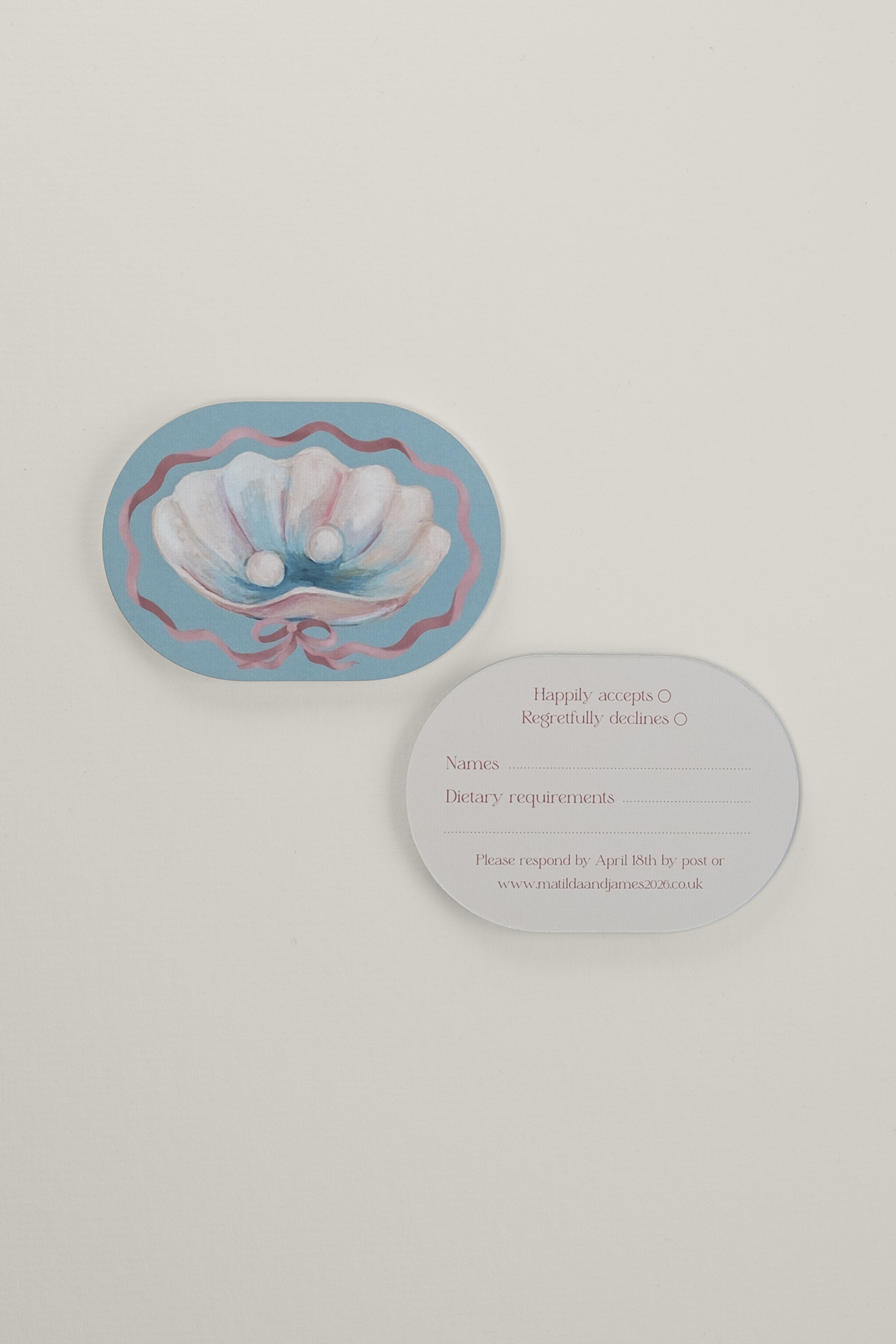 Front and reverse view of the double-arched Coquette wedding RSVP card, showing a pastel gouache shell illustration with pearls and a clean guest response layout.