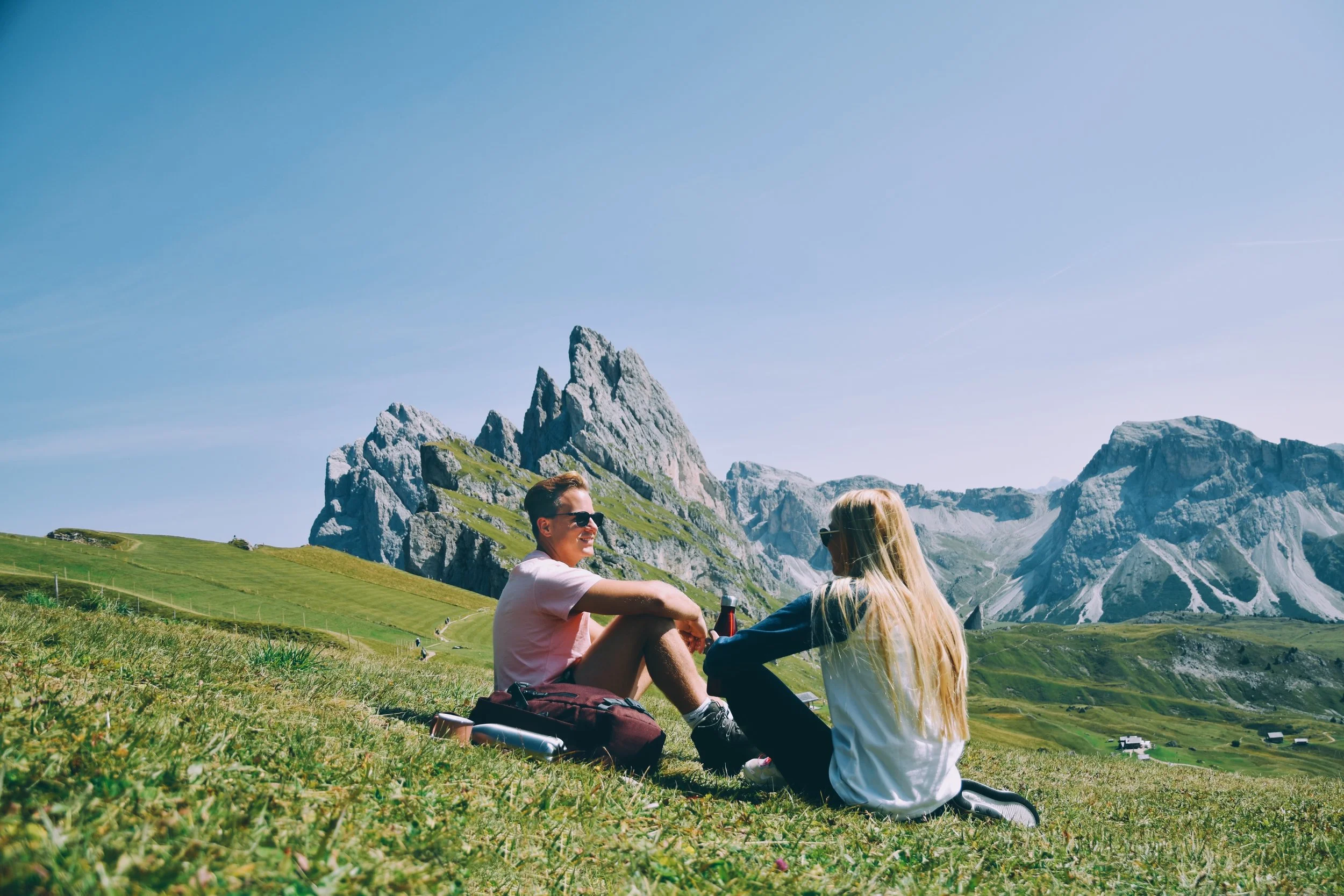 hiking-couple-taking-a-break-in-front-of-epic-moun-2026-03-13-01-54-51-utc.jpg