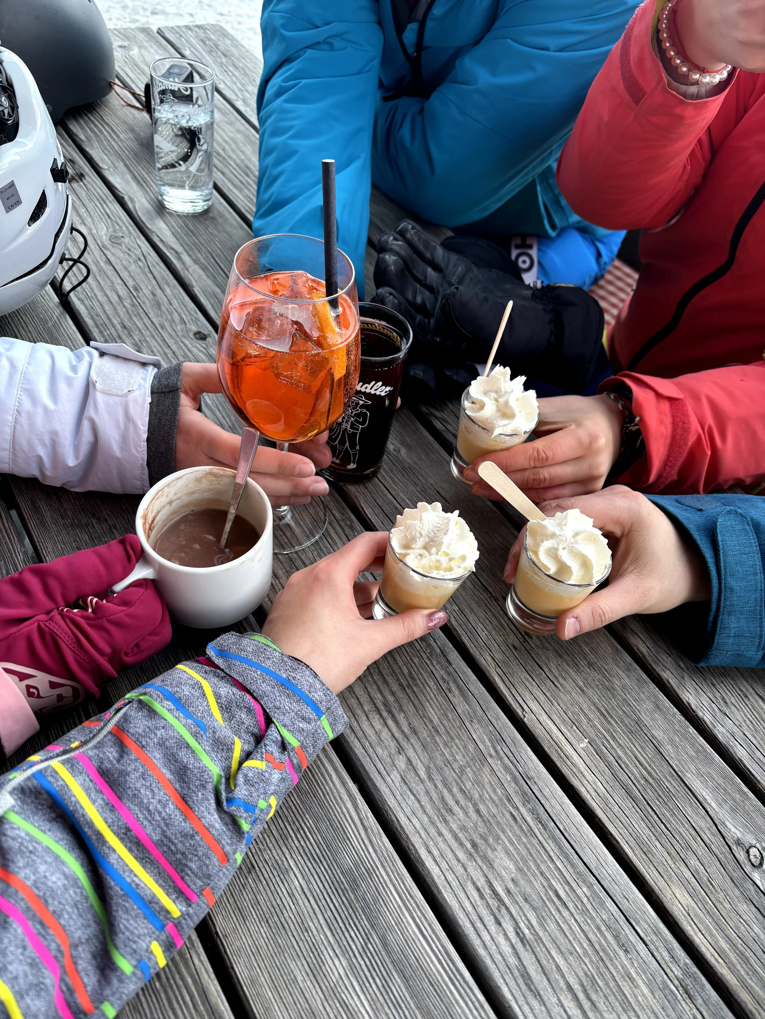 Tradičný taliansky nápoj Bombardino so šľahačkou na terase horskej chaty vo Val di Fassa.