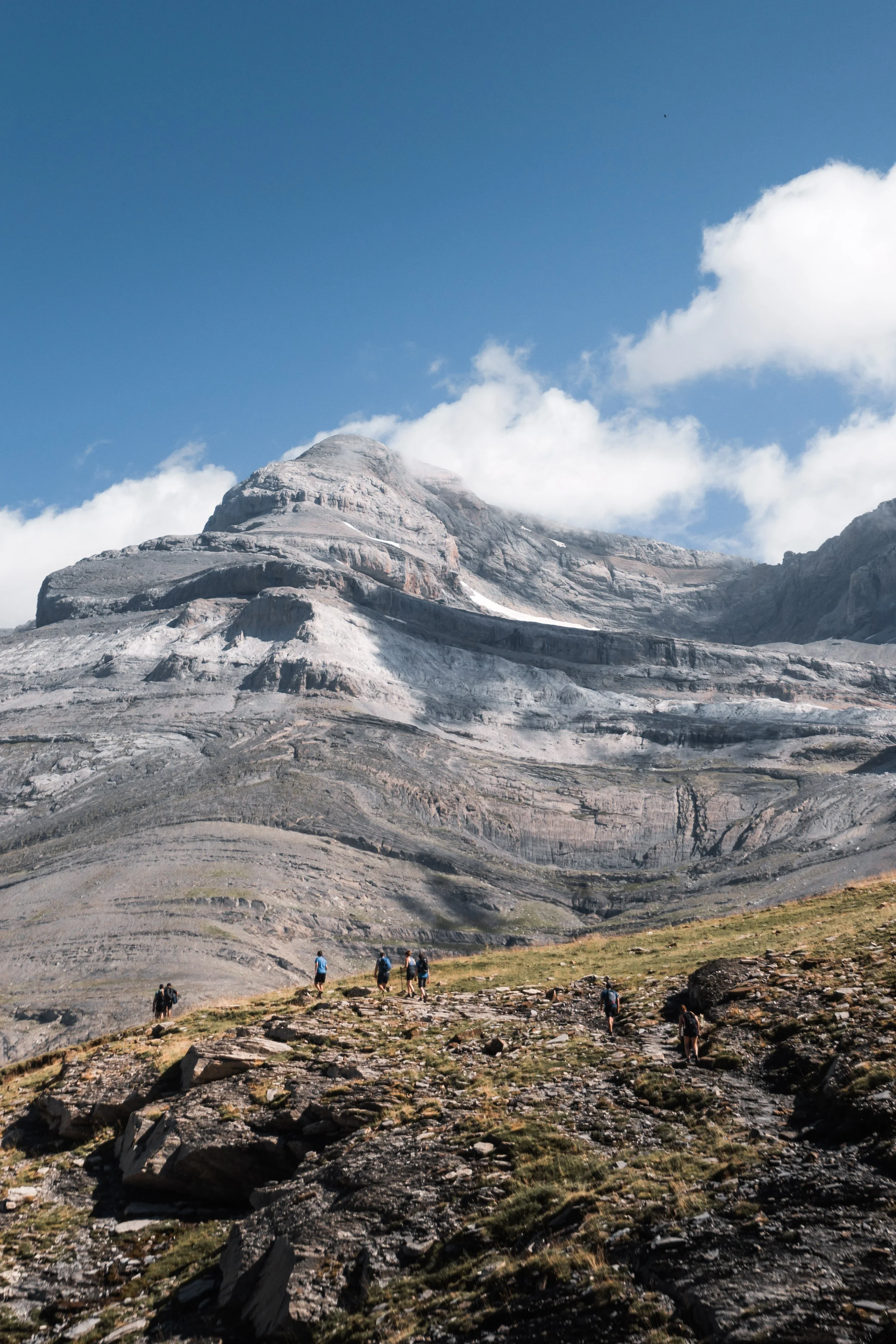 hikers-ascend-a-mountain-trail-on-a-sunny-day-2026-03-25-08-57-10-utc.jpg