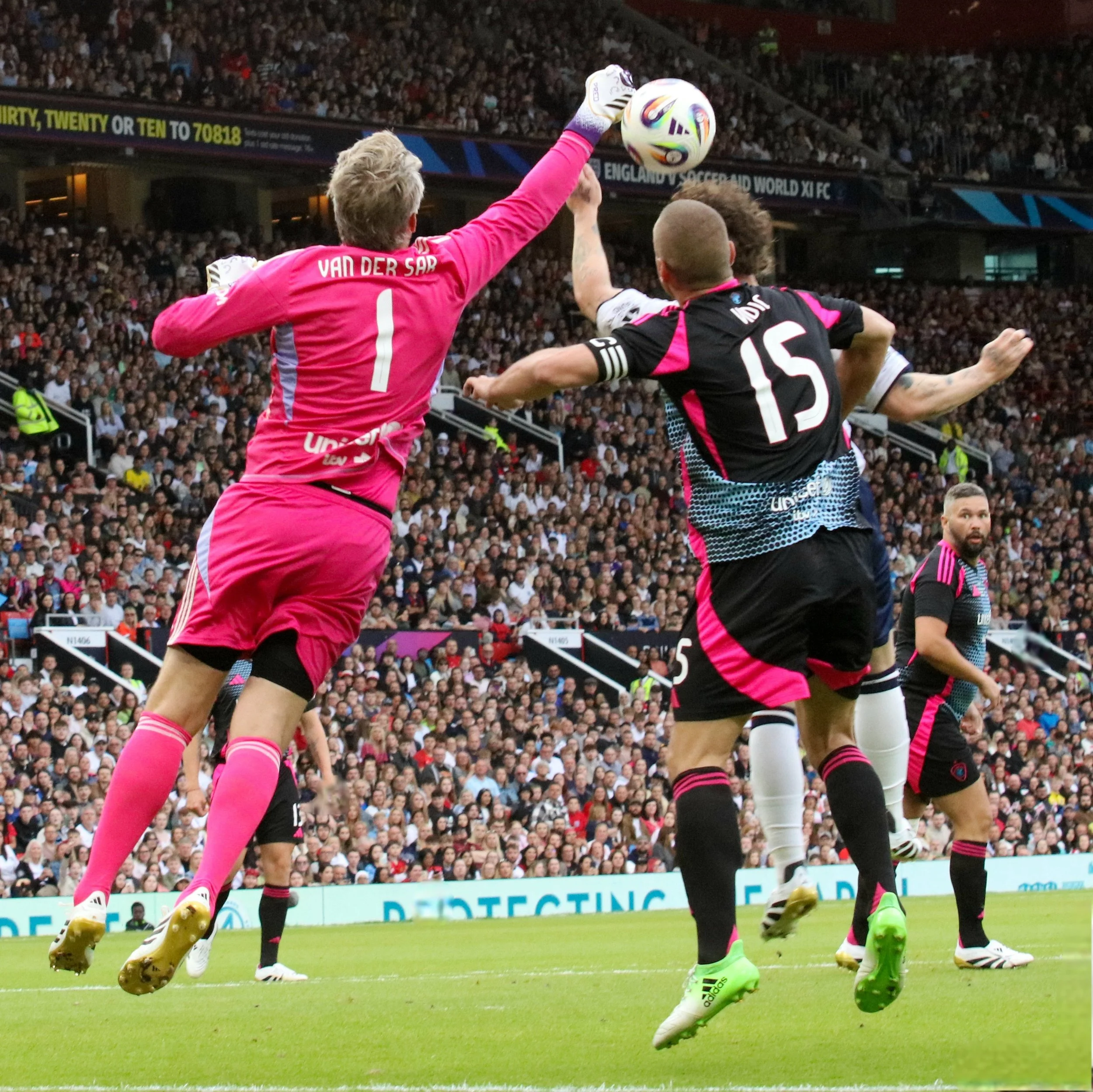Van der Sar knocks ball out of reach of danger.jpg