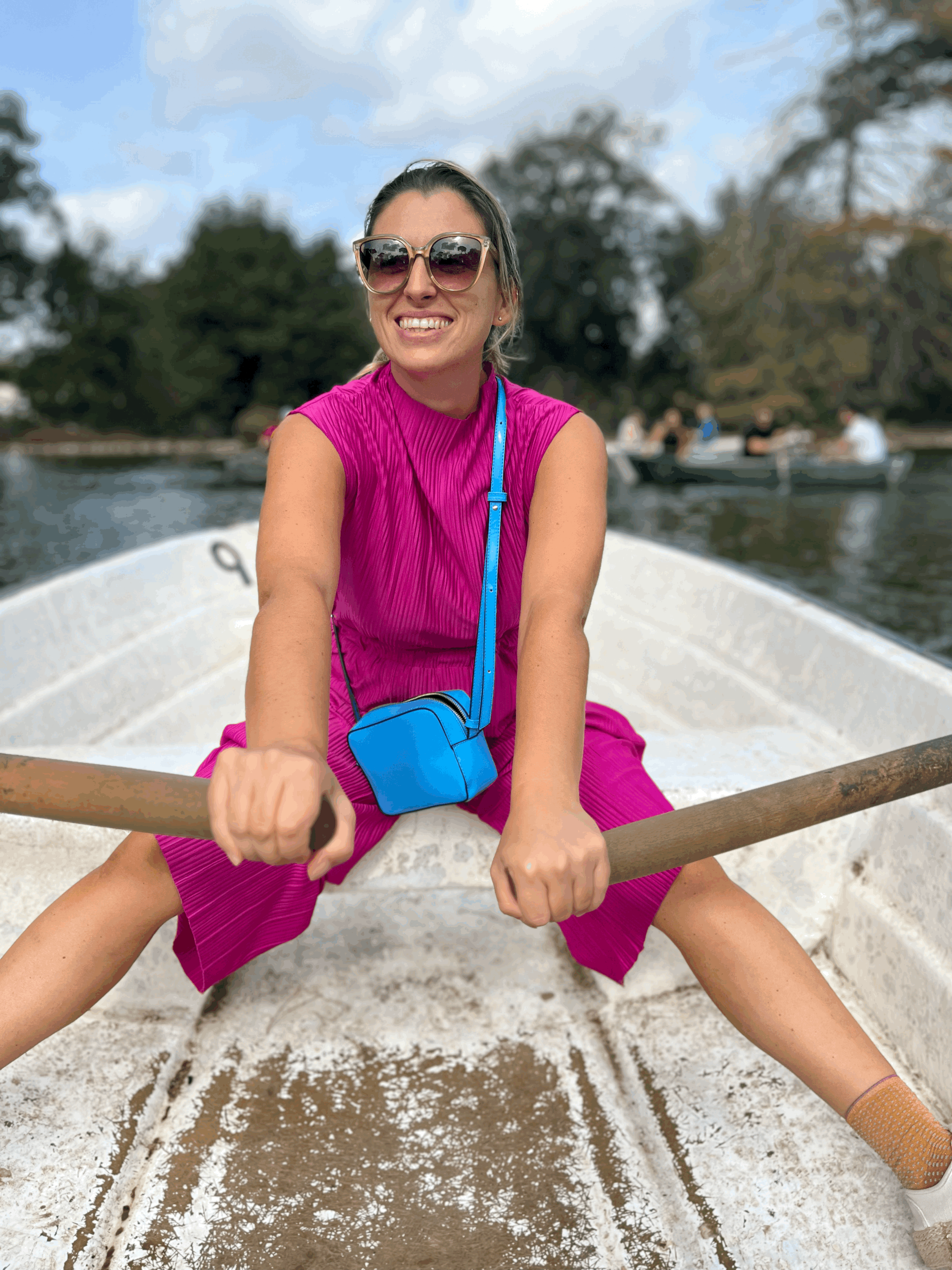 Young woman boating by the Villa Borghese's lake and temple