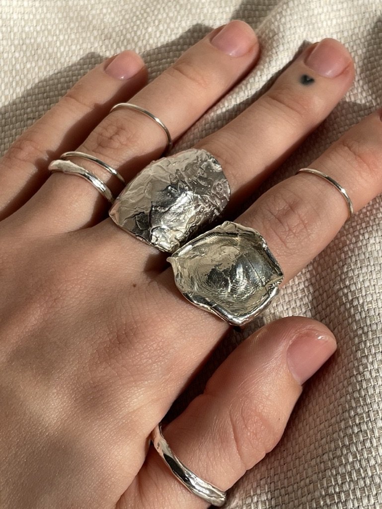 Silver Molten Signet Ring with other Gold Rings.jpeg