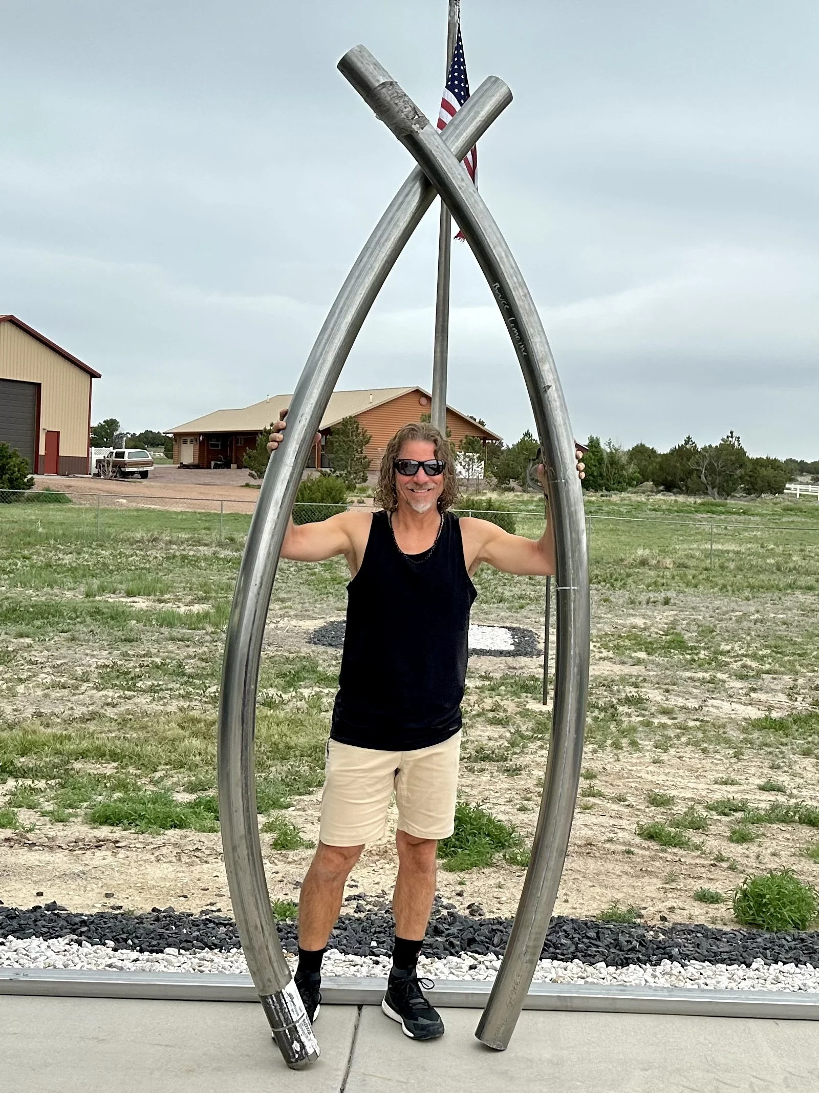 Martin Welch holding the stainless steel tubing that would eventually form the rails of the surfboard