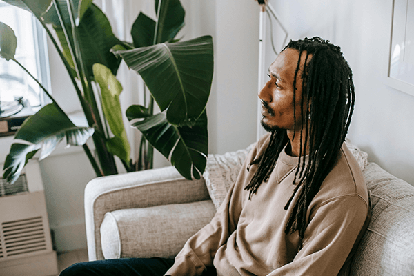 man sitting on couch in therapy office