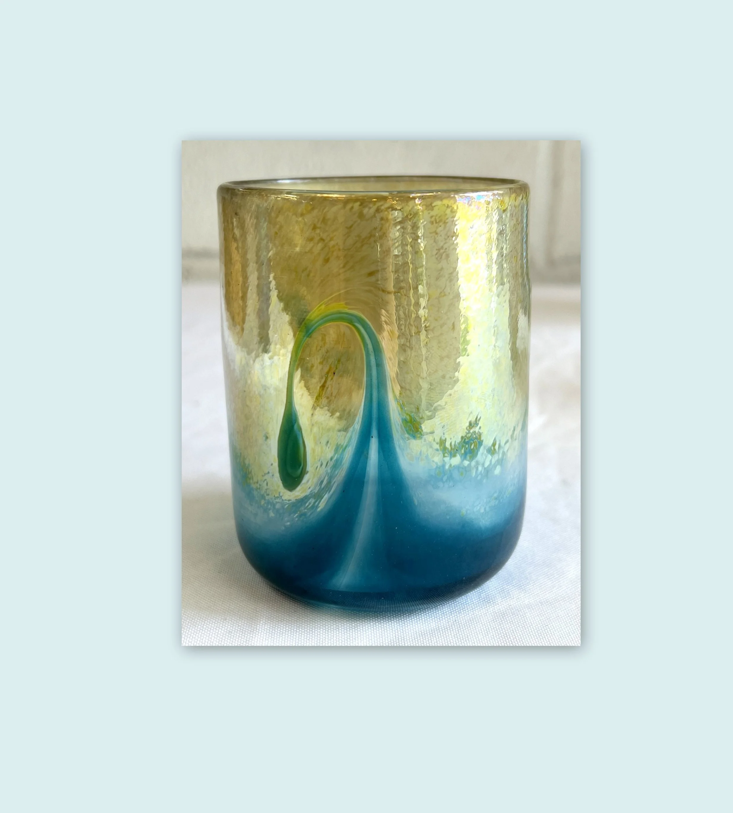 Gold Drinking Glass with Turquoise Wave Design.